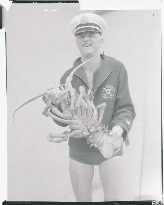 Framed Print : Lifeguard Displaying Large Lobster