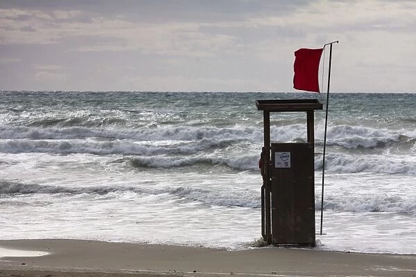 Lifeguard watch tower on the beach of Playa TorAzAa with a red Flag and waves, Peguera, Majorca, Balearic Islands, Spain, Europe