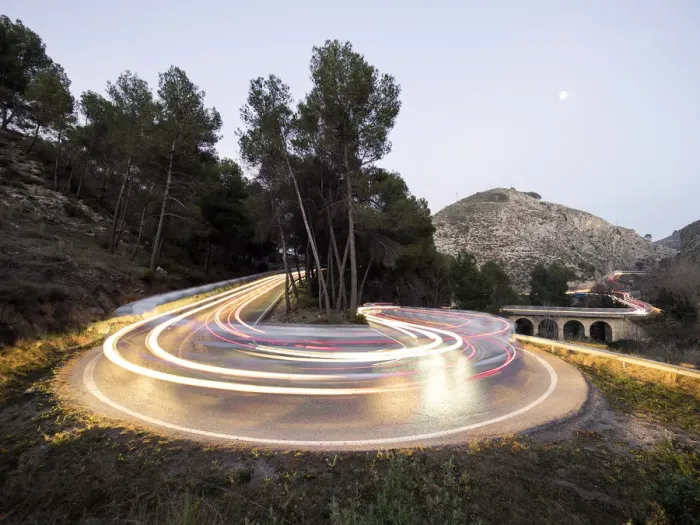 Framed Print : Lights of vehicles in movement circulating along a carretera with curves very closed in the moonlight Framed Print : Lights of vehicles in movement circulating along a carretera with curves very closed in the moonlight
