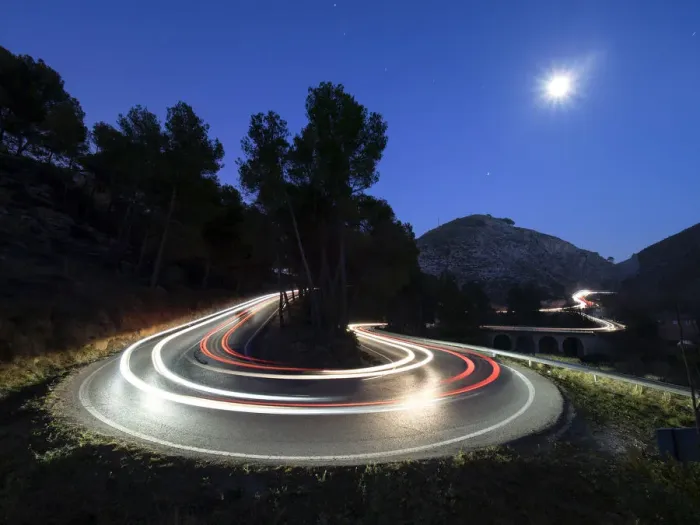 Framed Print : Lights of vehicles in movement circulating along a carretera with curves very closed in the moonlight Framed Print : Lights of vehicles in movement circulating along a carretera with curves very closed in the moonlight