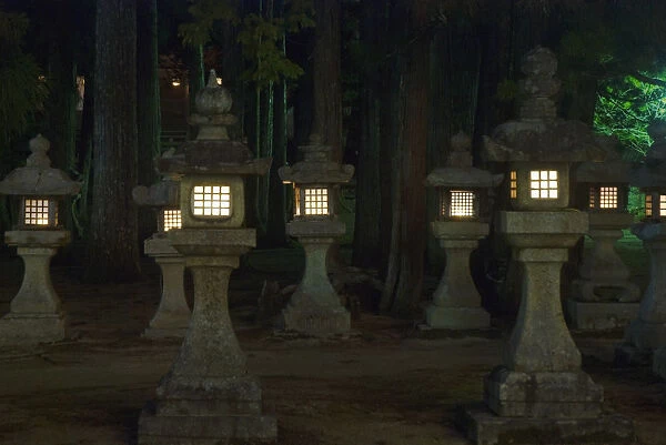 Lit Japanese Stone Lanterns At Night