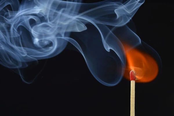 Lit matchstick with a flame and smoke, Germany