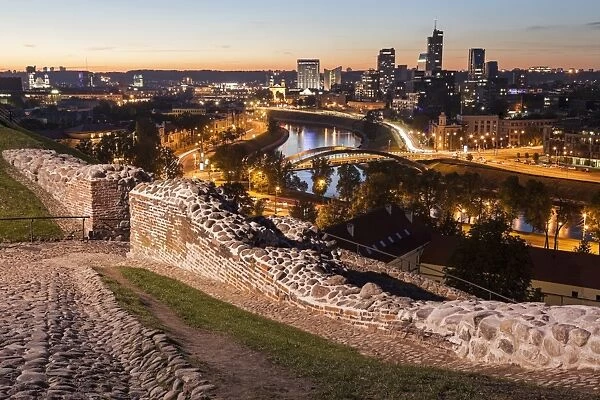 Lithuania, Vilnius, Illuminated riverfront cityscape seen from elevation on opposite bank