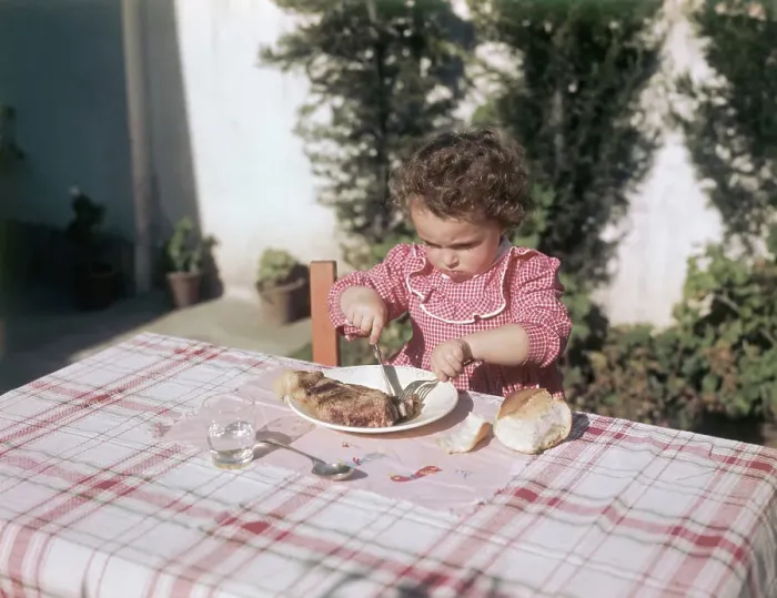 Framed Print : Little Girl Eating Big Steak Framed Print : Little Girl Eating Big Steak