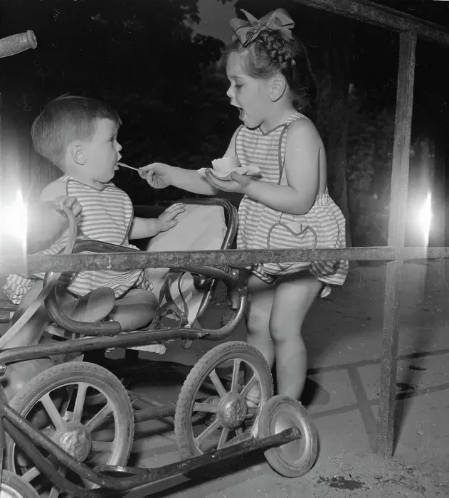 Framed Print : Little Girl Feeding Ice Cream To Younger Brother Framed Print : Little Girl Feeding Ice Cream To Younger Brother