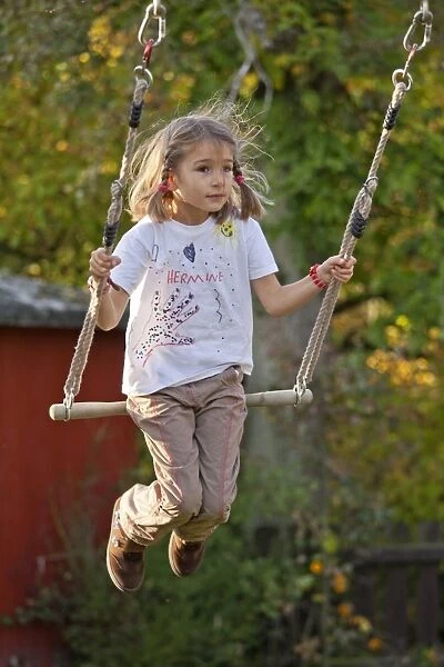 Little girl on a swing