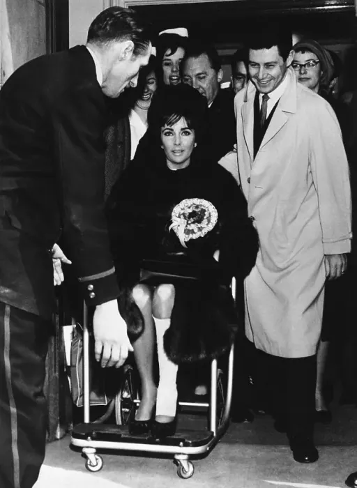 Framed Print : Liz Taylor Being Pushed in Wheelchair Framed Print : Liz Taylor Being Pushed in Wheelchair