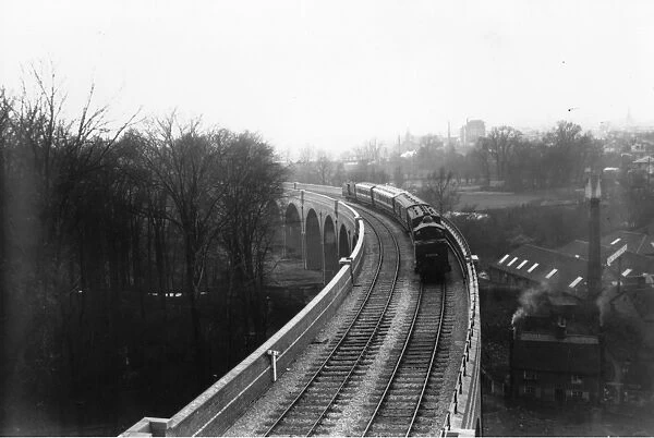 LNW Train. 1913: A train crossing a viaduct on the line