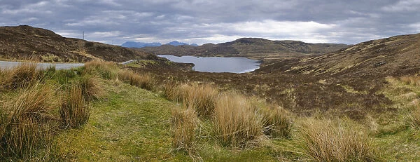 Loch Dhughaill towards the distant Cuillin Hills, Sleat Peninsula, near the town of Tarskavaig, Isle of Skye, Highland, Scotland, United Kingdom, Europe