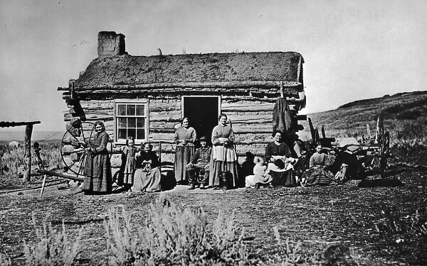 Log Cabin. Women and children outside a log cabin. (Photo by Hulton Archive / Getty Images)