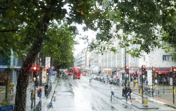 London street scene through rain-soaked bus windows, London, England, United Kingdom