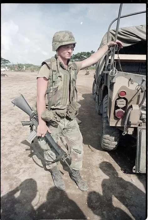 Framed Print : Lone Soldier in Grenada Leans on Truck Framed Print : Lone Soldier in Grenada Leans on Truck