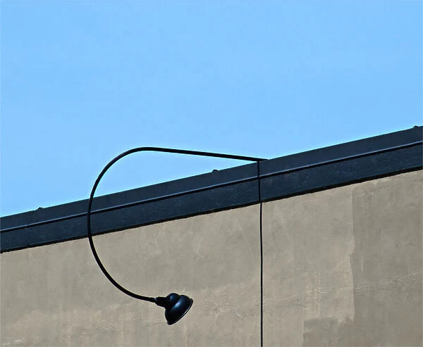Long Lamp. A color photograph of an outside lamp on the roof of a commercial
