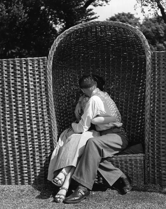 Framed Print : Love Seat. A couple kissing in one of the wicker alcove chairs at Battersea Framed Print : Love Seat. A couple kissing in one of the wicker alcove chairs at Battersea
