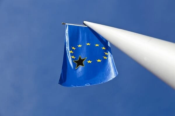 Low angle view of a European Union flag with one black star on it