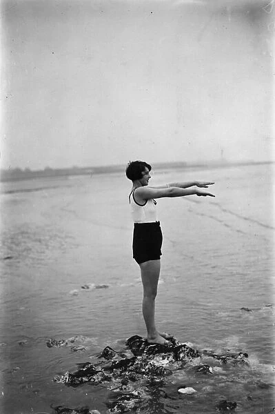 Low Dive. 25th March 1929: A swimmer prepares for a plunge into the sea at Margate, Kent