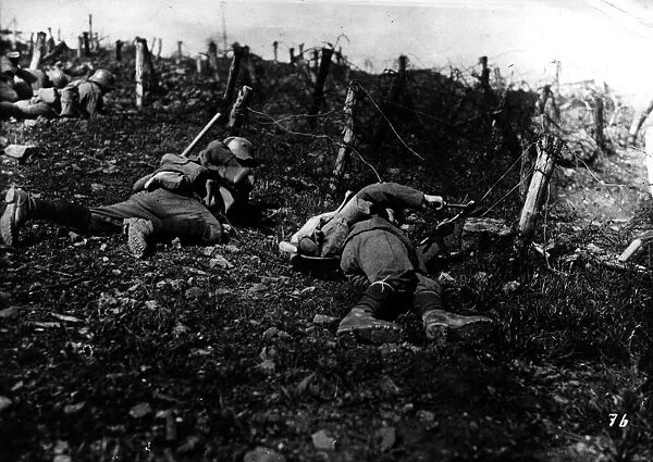 Lying Low. circa 1916: German troops cutting through barbed wire