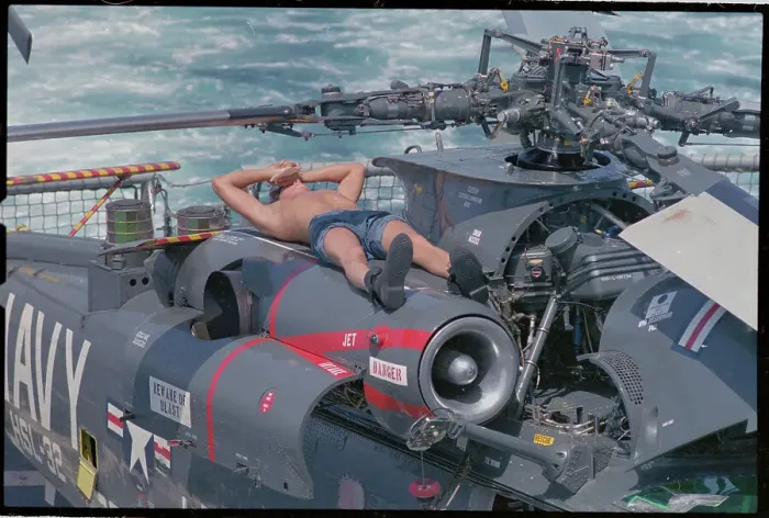 Framed Print : Machinist Relaxing Atop Helicopter