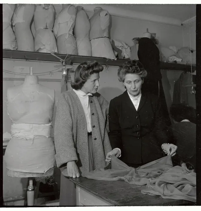 Framed Print : Mad Carpentier and Assistant Discussing Fabric Framed Print : Mad Carpentier and Assistant Discussing Fabric