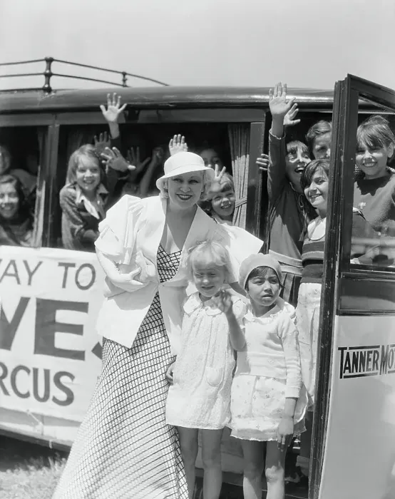 Framed Print : Mae West Posing with Orphans by Circus Bus Framed Print : Mae West Posing with Orphans by Circus Bus