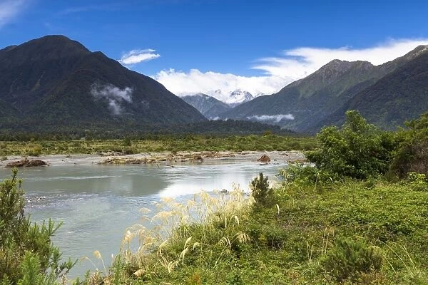 Mahitahi River with views towards the Bannock Brea Range and the snow-capped Mount Stratford, 1977m, Southern Alps, Bruce Bay, West Coast Region, New Zealand