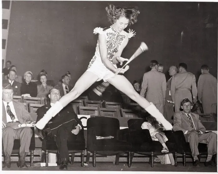 Framed Print : Majorette Jumping While Twirling Baton
