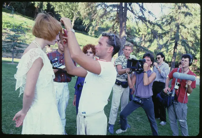 Framed Print : Makeup Artist Adjusting Model's Hair on Outdoor Shoot Framed Print : Makeup Artist Adjusting Model's Hair on Outdoor Shoot