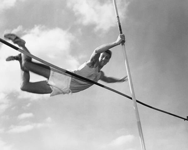 Male pole-vaulter clearing bar