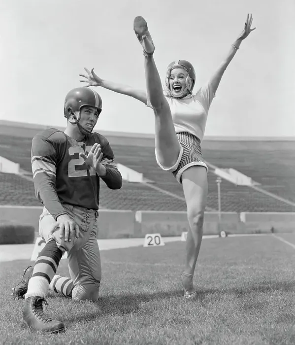 Framed Print : Mamie Van Doren Kicking on Football Field with Jim Sears Framed Print : Mamie Van Doren Kicking on Football Field with Jim Sears