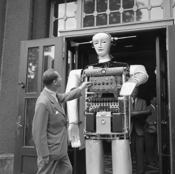 Framed Print : Man Adjusting Louie the Robot Framed Print : Man Adjusting Louie the Robot
