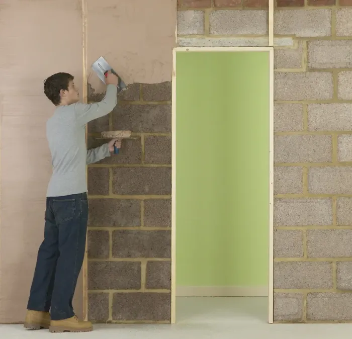 Framed Print : Man applying plaster to wall Framed Print : Man applying plaster to wall