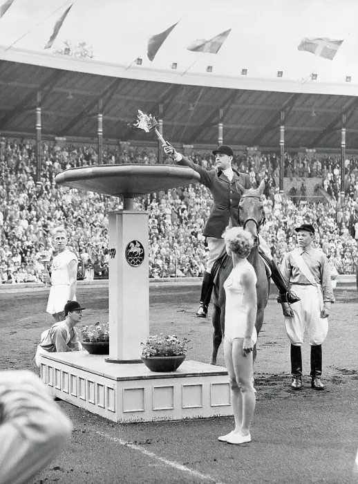 Framed Print : Man Applying Torch to Olympic Flame Framed Print : Man Applying Torch to Olympic Flame