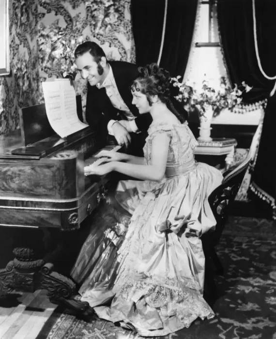 Framed Print : Man assisting woman playing on spinet (B&W) Framed Print : Man assisting woman playing on spinet (B&W)