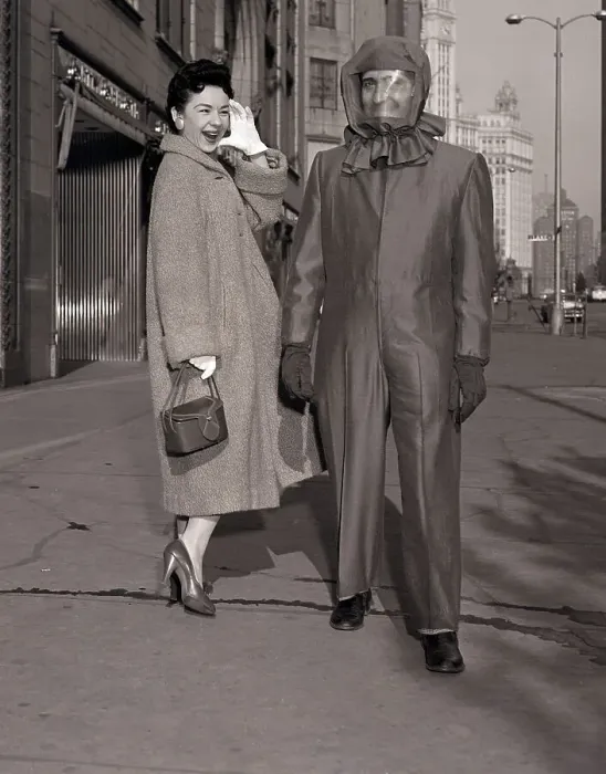 Framed Print : Man in Atomic-Shelter Suit with Woman Laughing Framed Print : Man in Atomic-Shelter Suit with Woman Laughing