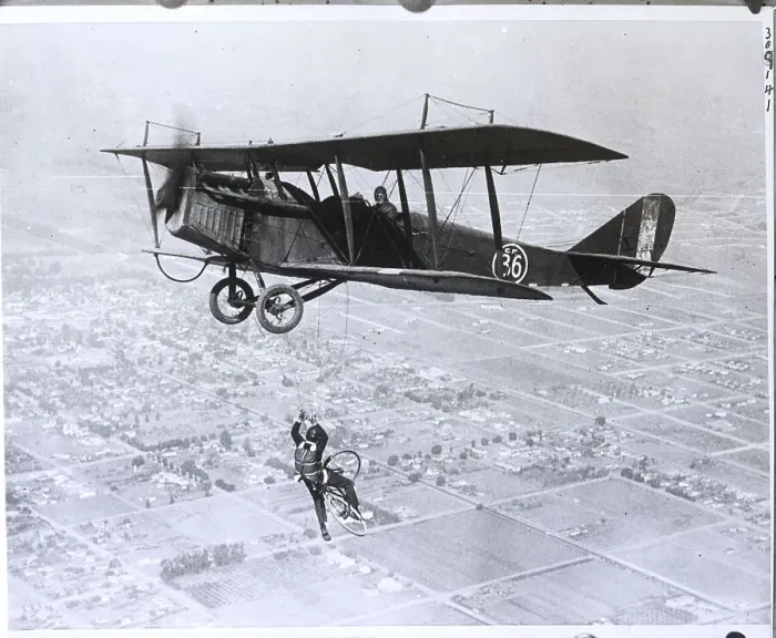 Framed Print : Man On Bicycle Falling From Plane Framed Print : Man On Bicycle Falling From Plane