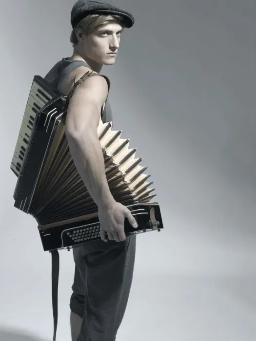 Framed Print : Man carrying an accordion, fashion shoot