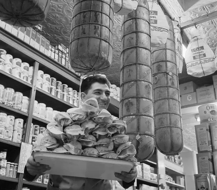 Framed Print : Man Carrying Hero Sandwiches Below Large Cheeses Framed Print : Man Carrying Hero Sandwiches Below Large Cheeses