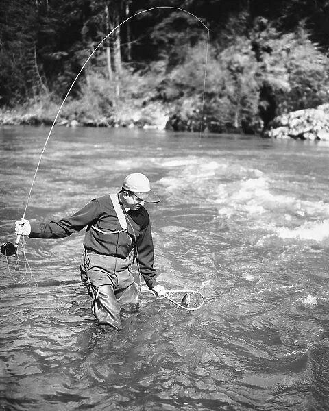 Man catching fish in river