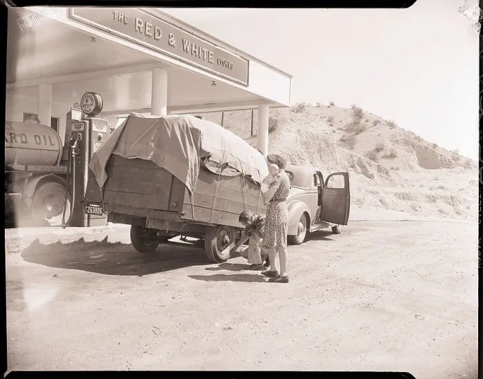Framed Print : Man Checks Trailer Tires at Gas Station Framed Print : Man Checks Trailer Tires at Gas Station
