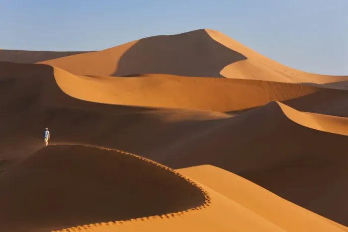 Framed Print : Man Climbing Sand Dunes, Namib Desert, Namibia Framed Print : Man Climbing Sand Dunes, Namib Desert, Namibia
