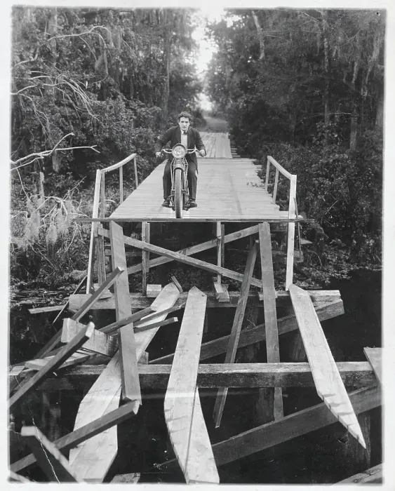 Framed Print : Man Crossing Bridge on Motorcycle Framed Print : Man Crossing Bridge on Motorcycle