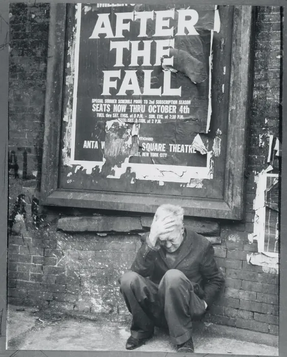 Framed Print : Man Crouching Beneath a Tattered Poster Framed Print : Man Crouching Beneath a Tattered Poster