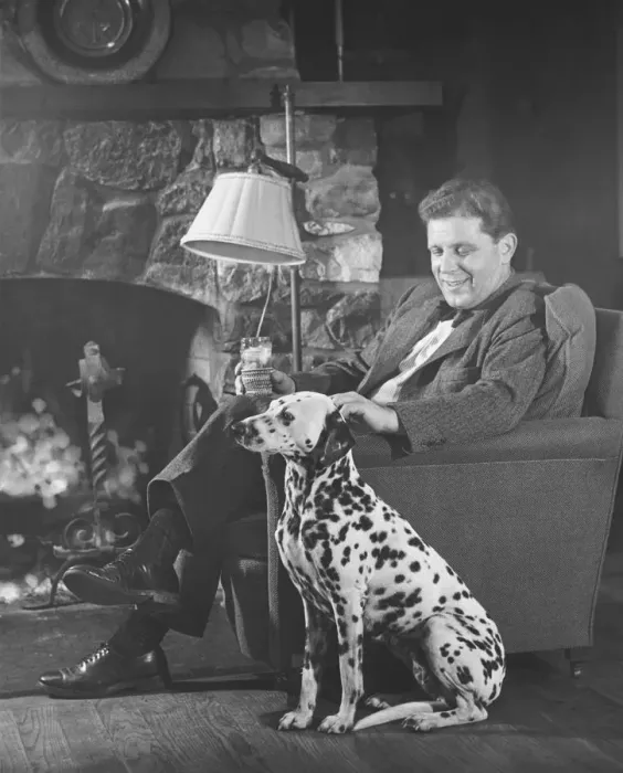 Framed Print : Man with dalmatian sitting at fireplace (B&W) Framed Print : Man with dalmatian sitting at fireplace (B&W)