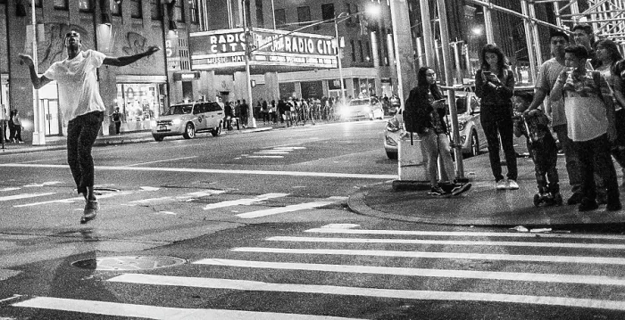 Framed Print : Man dancing in the street down the street from Radio City Music Hall