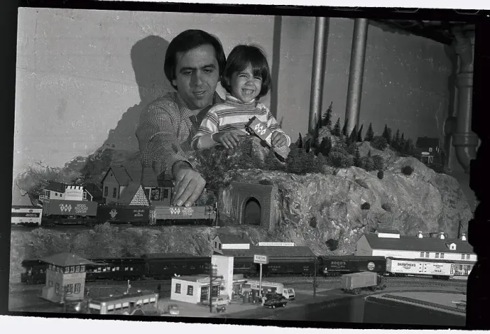 Framed Print : Man and Daughter Running Toy Trains Framed Print : Man and Daughter Running Toy Trains