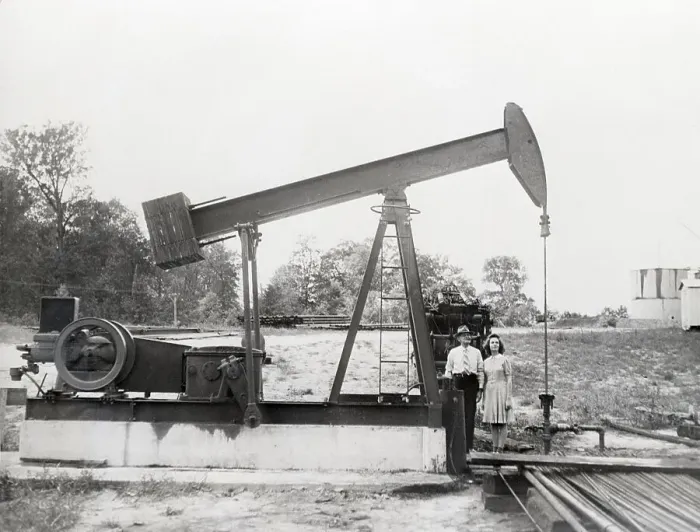 Framed Print : Man & Daughter Stand Under Old Oil Drill Framed Print : Man & Daughter Stand Under Old Oil Drill