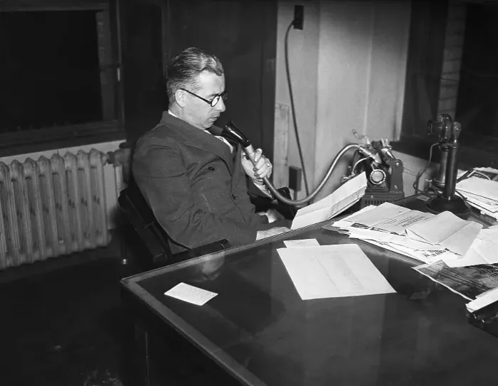 Framed Print : Man at Desk Dictates into Dictaphone