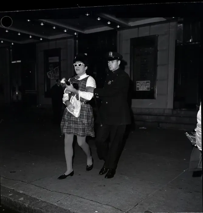 Framed Print : Man Dressed As Woman Led Off By Policema Framed Print : Man Dressed As Woman Led Off By Policema