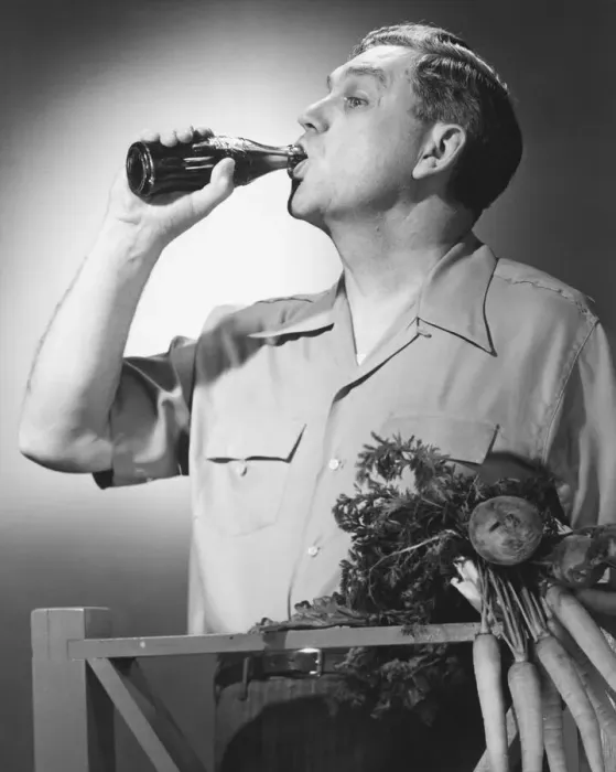 Framed Print : Man drinking cola from bottle in studio (B&W) Framed Print : Man drinking cola from bottle in studio (B&W)