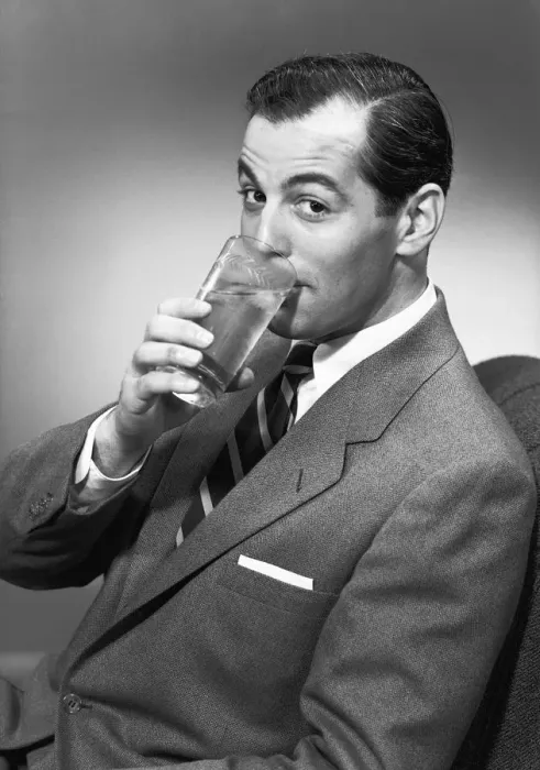 Framed Print : Man drinking water from glass, posing in studio, (B&W), portrait Framed Print : Man drinking water from glass, posing in studio, (B&W), portrait